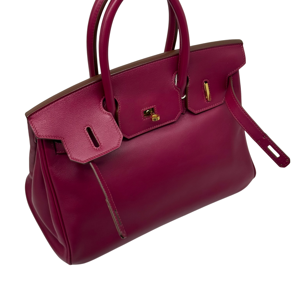 Magenta leather Birkin bag with front flap pocket and gold-tone clasp