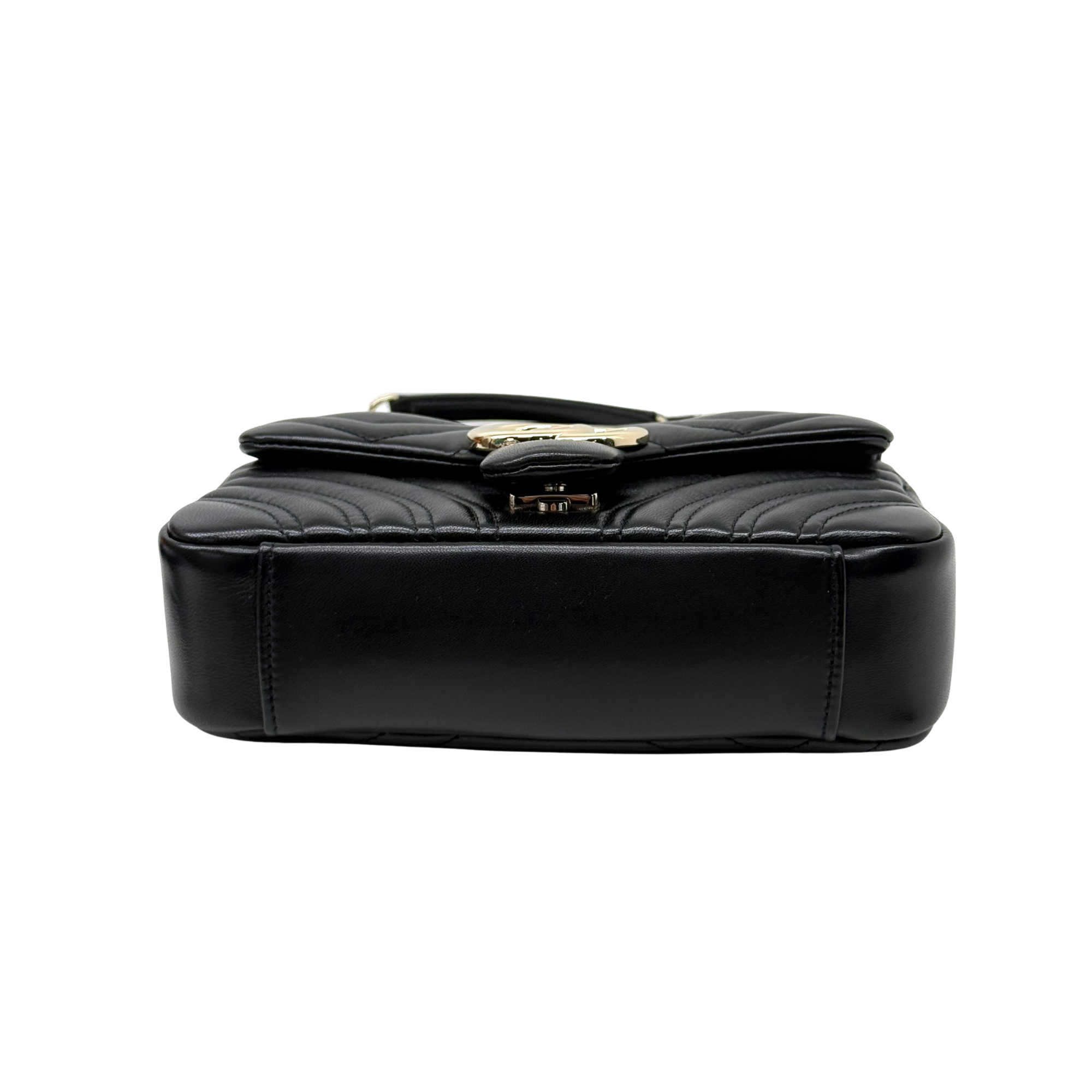 Gucci shoulder bag top view with black quilted leather flap and gold clasp