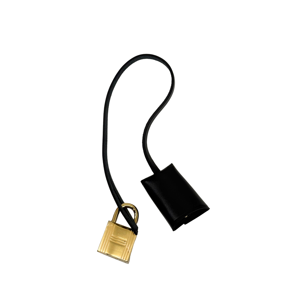 Hermes black leather strap with gold padlock charm and black leather sleeve