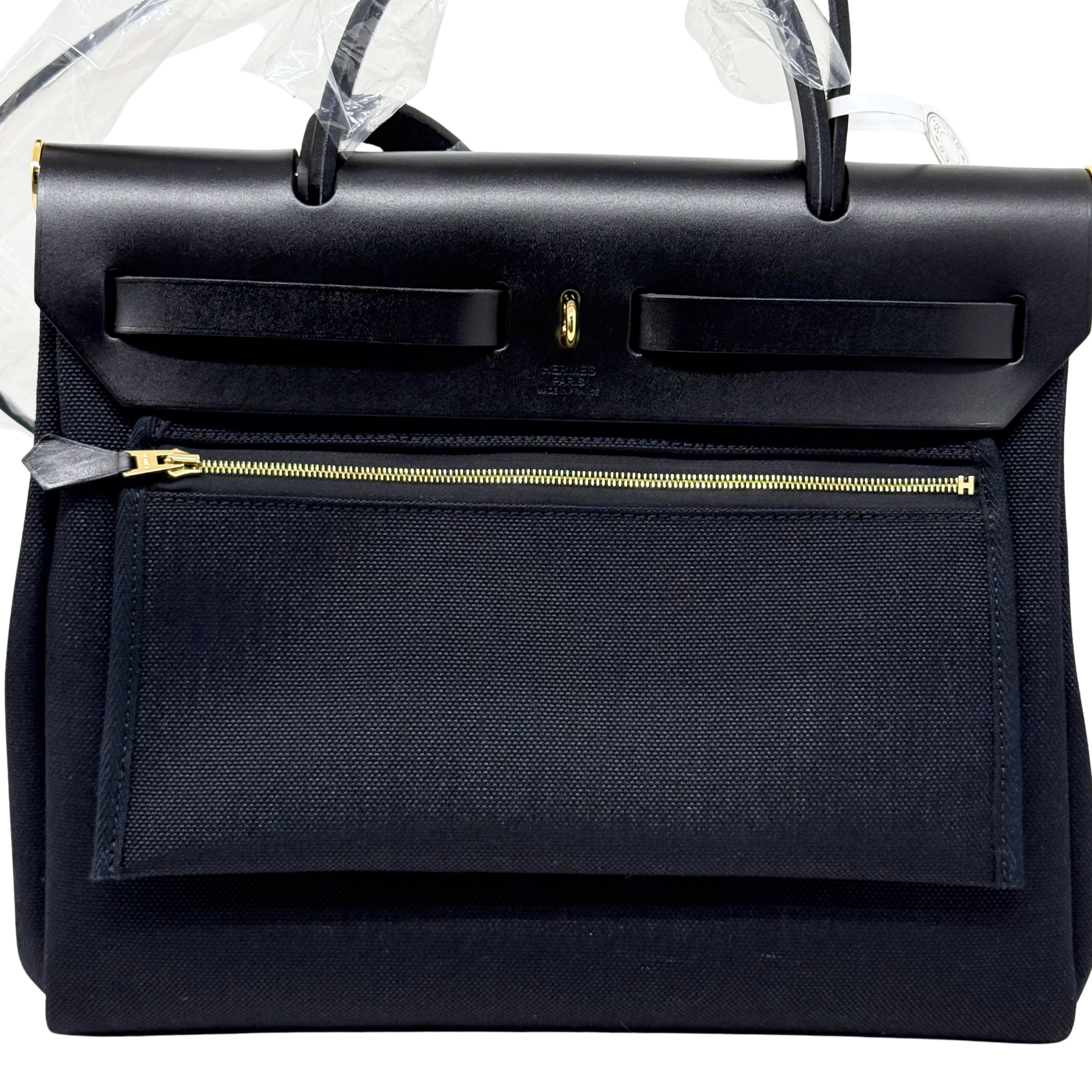 Hermes black leather handbag with front flap and gold-tone zipper pocket