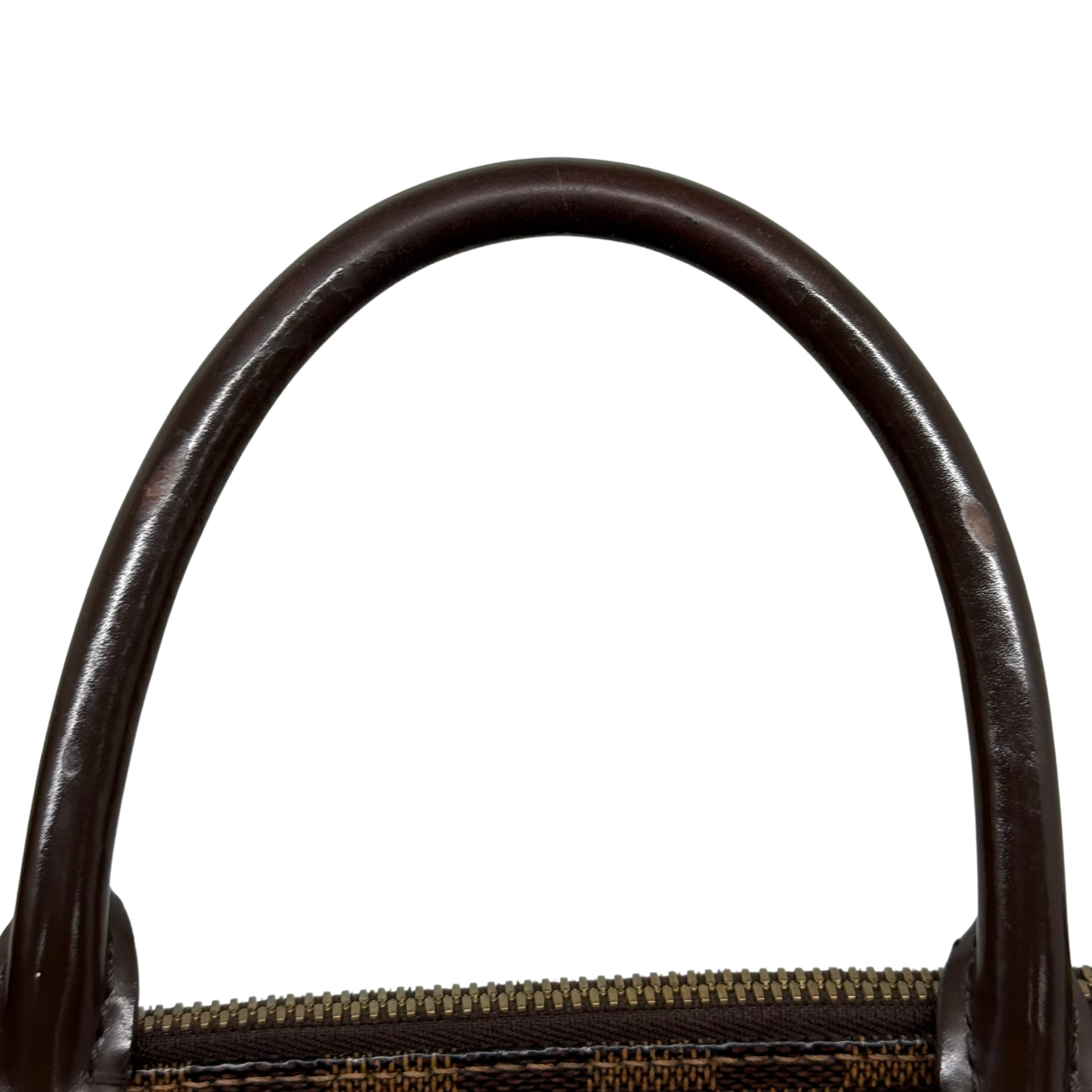 Pre-owned Louis Vuitton handbag handle close-up above zipper with checkered canvas