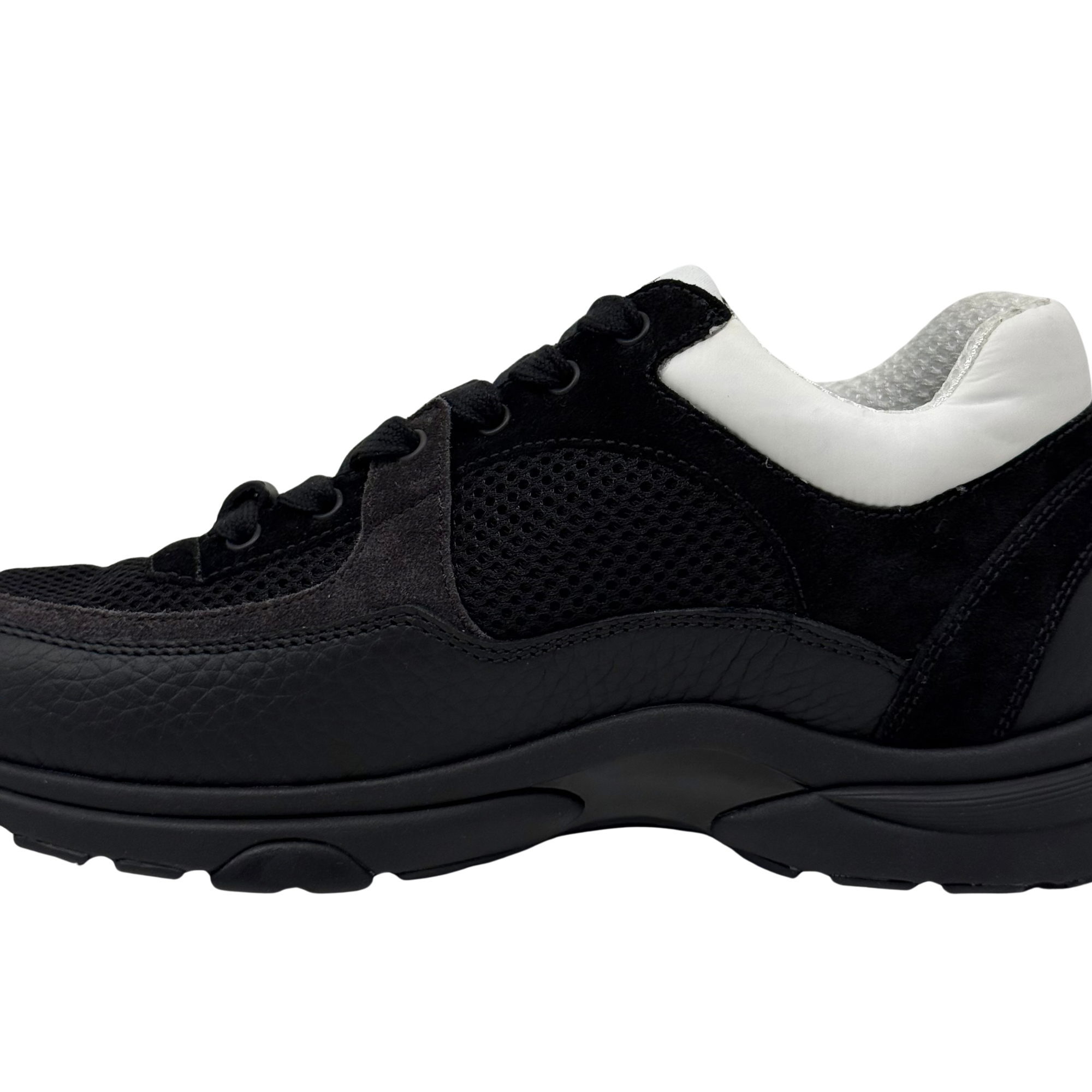 Black and white low-top sneakers with mesh panels, padded collar, thick tread sole.