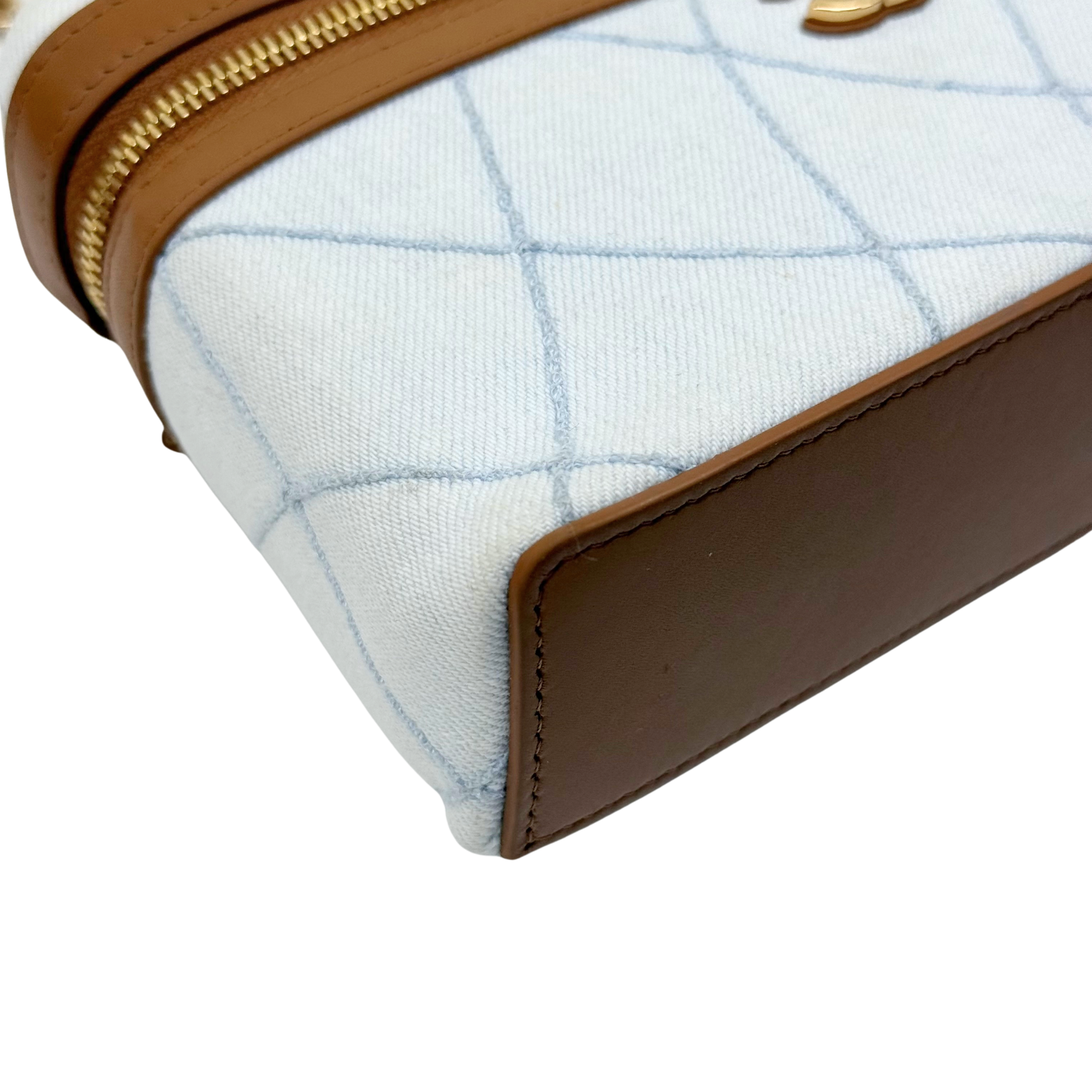 Chanel light-blue quilted corner view with brown leather edge and gold-tone zipper