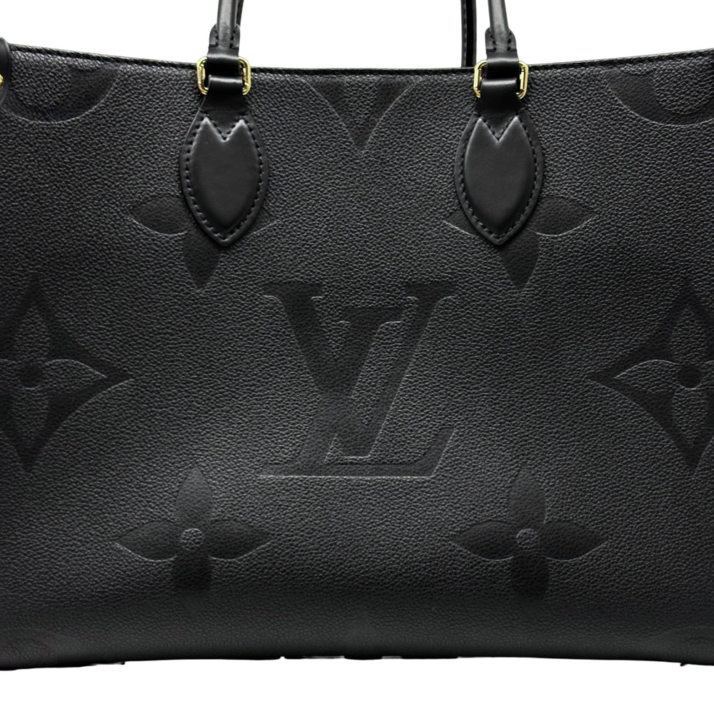 Pre-owned Louis Vuitton black monogram tote bag close-up of front panel and leather handle tabs