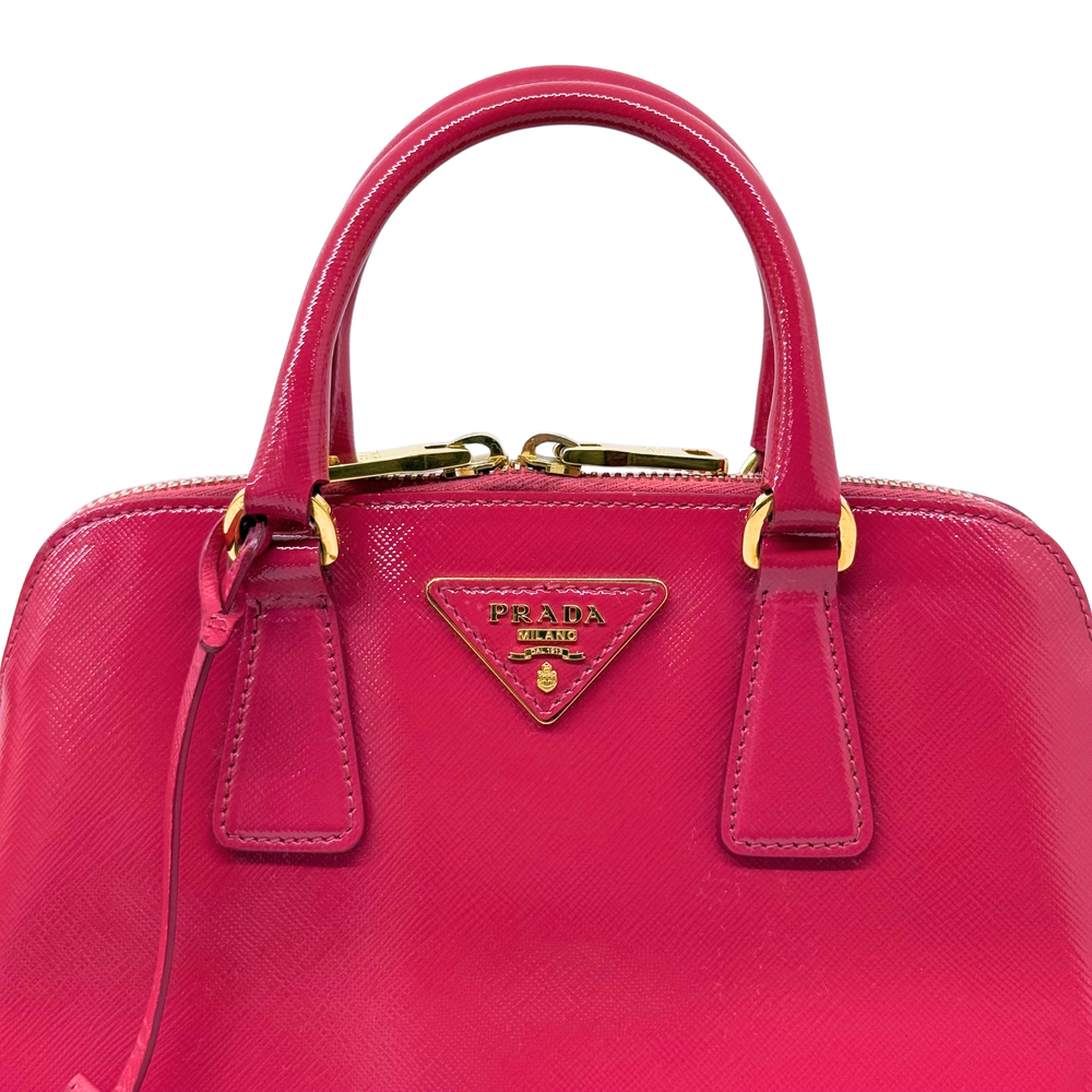 Pink Prada handbag front with triangular logo plaque and two front leather pockets