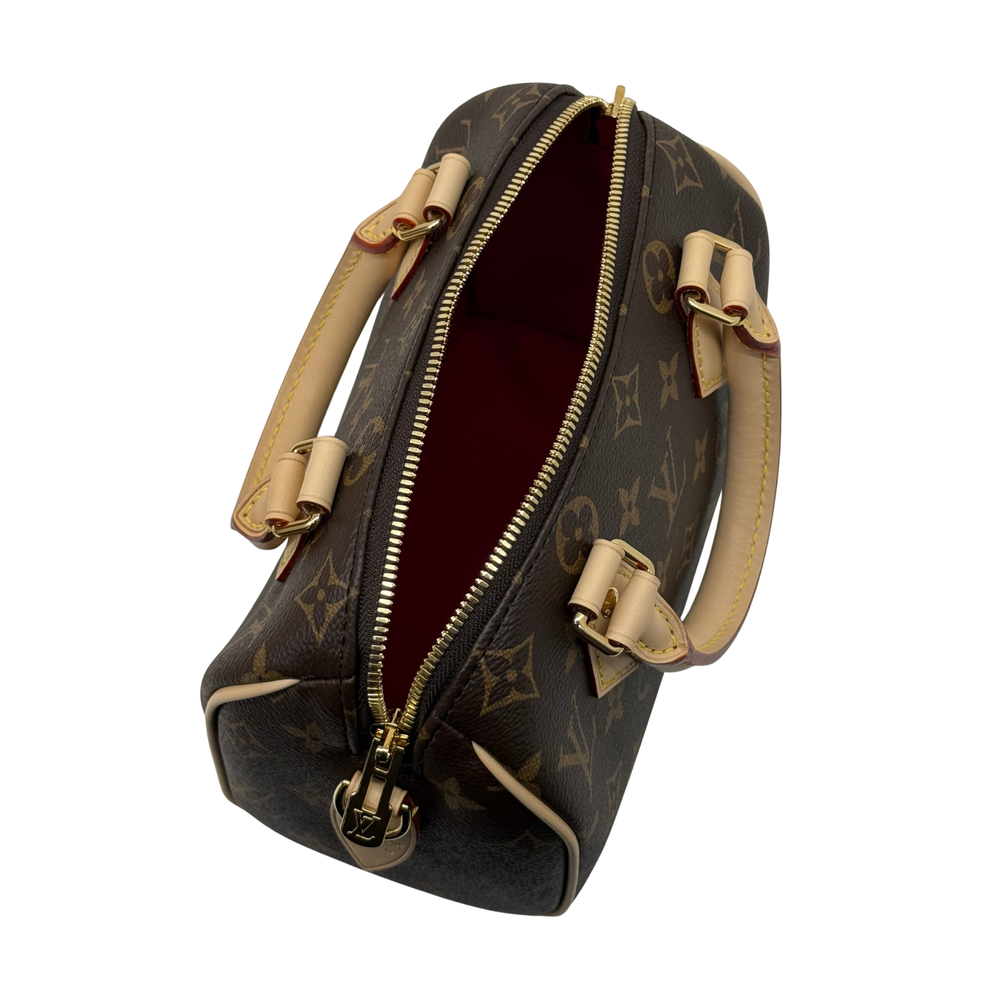 Louis Vuitton monogram handbag open top with red interior and gold zipper