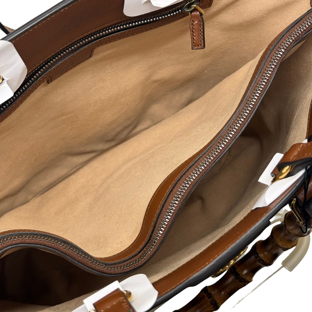 Beige interior of brown Gucci tote with zipper track and stitched trim