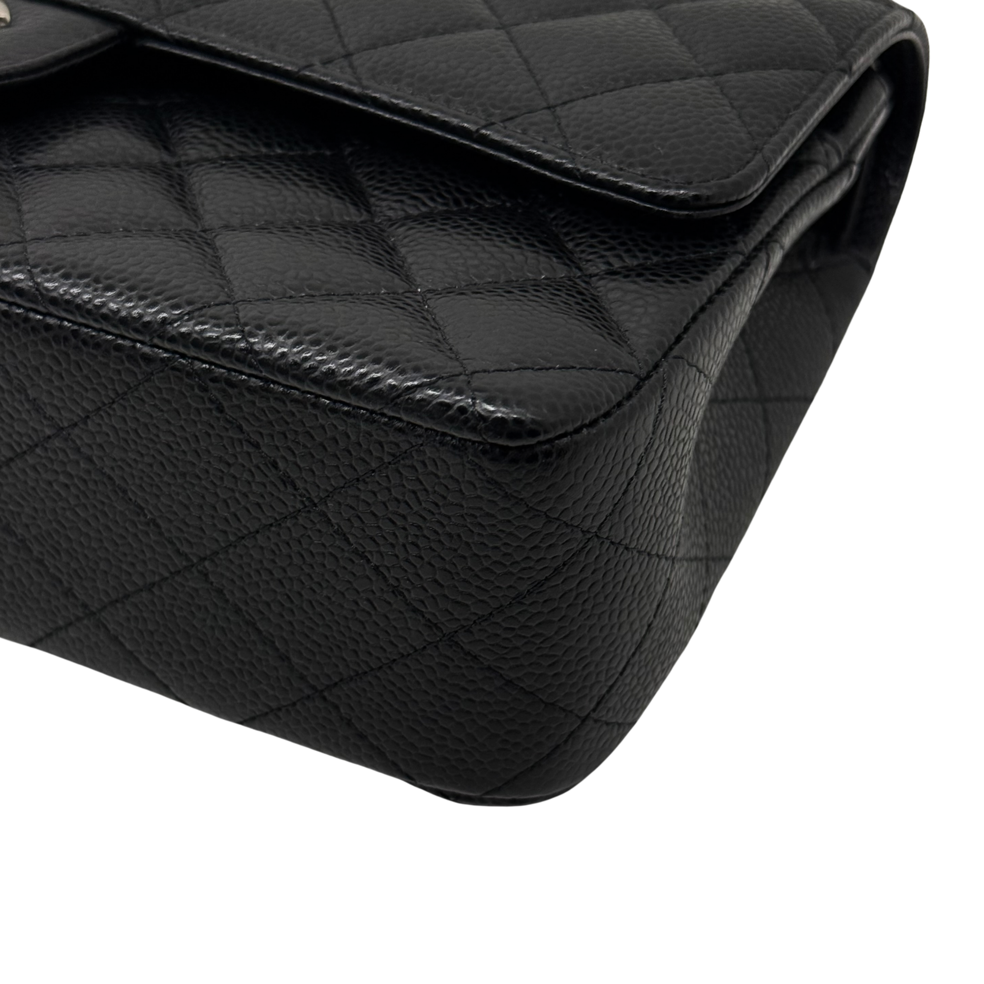 Black quilted leather corner with stitched trim and curved flap edge