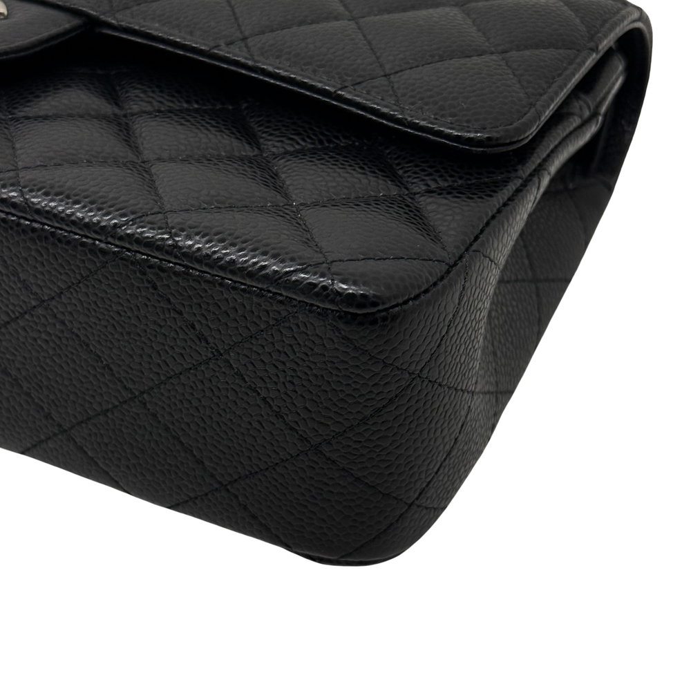 Black quilted leather corner with stitched trim and curved flap edge