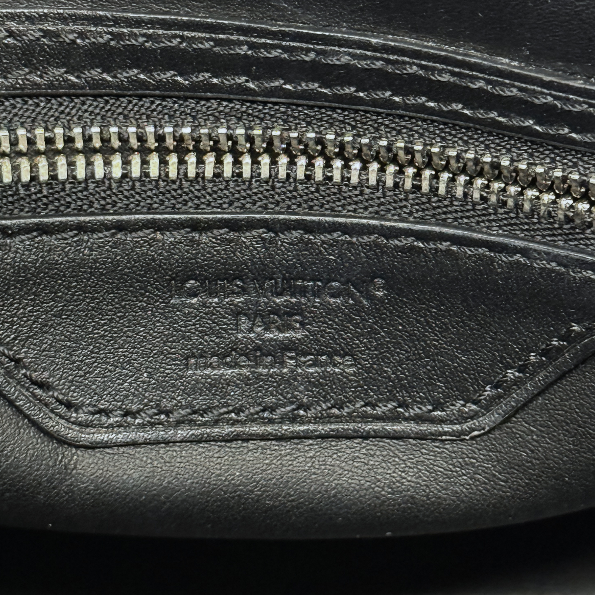 Louis Vuitton pre-owned bag interior leather pocket with zipper and stamped logo