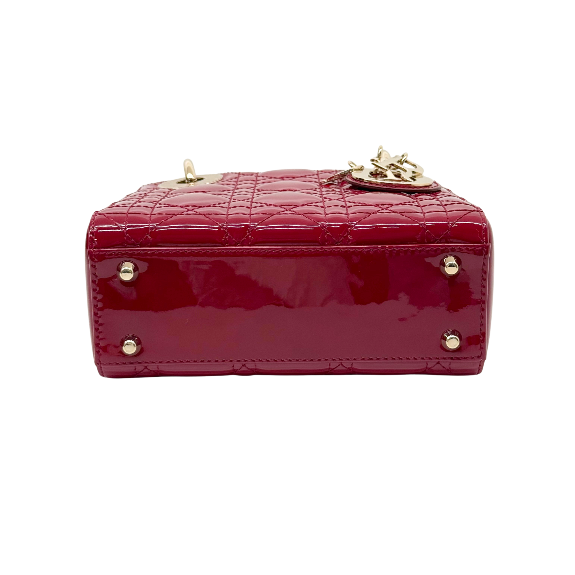 Red quilted patent handbag with gold top clasp and chain hardware