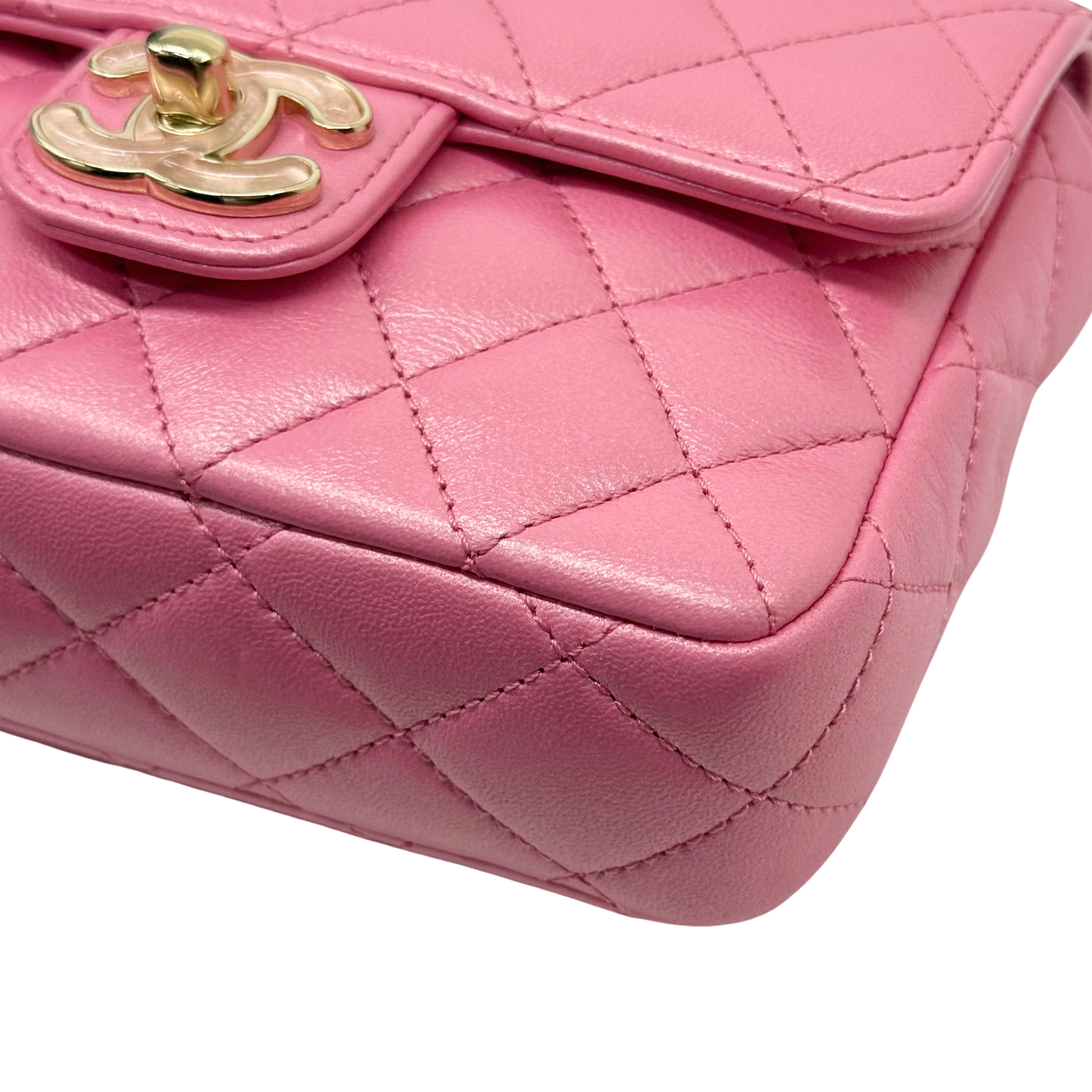 Pink quilted leather mini bag with gold clasp and stitched edge detail