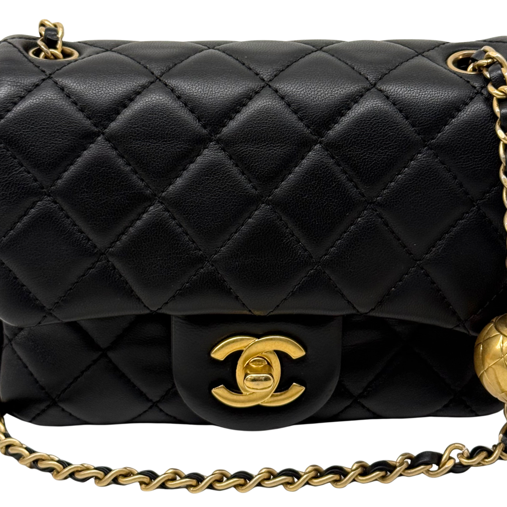Black quilted flap shoulder bag with gold CC logo and braided chain strap