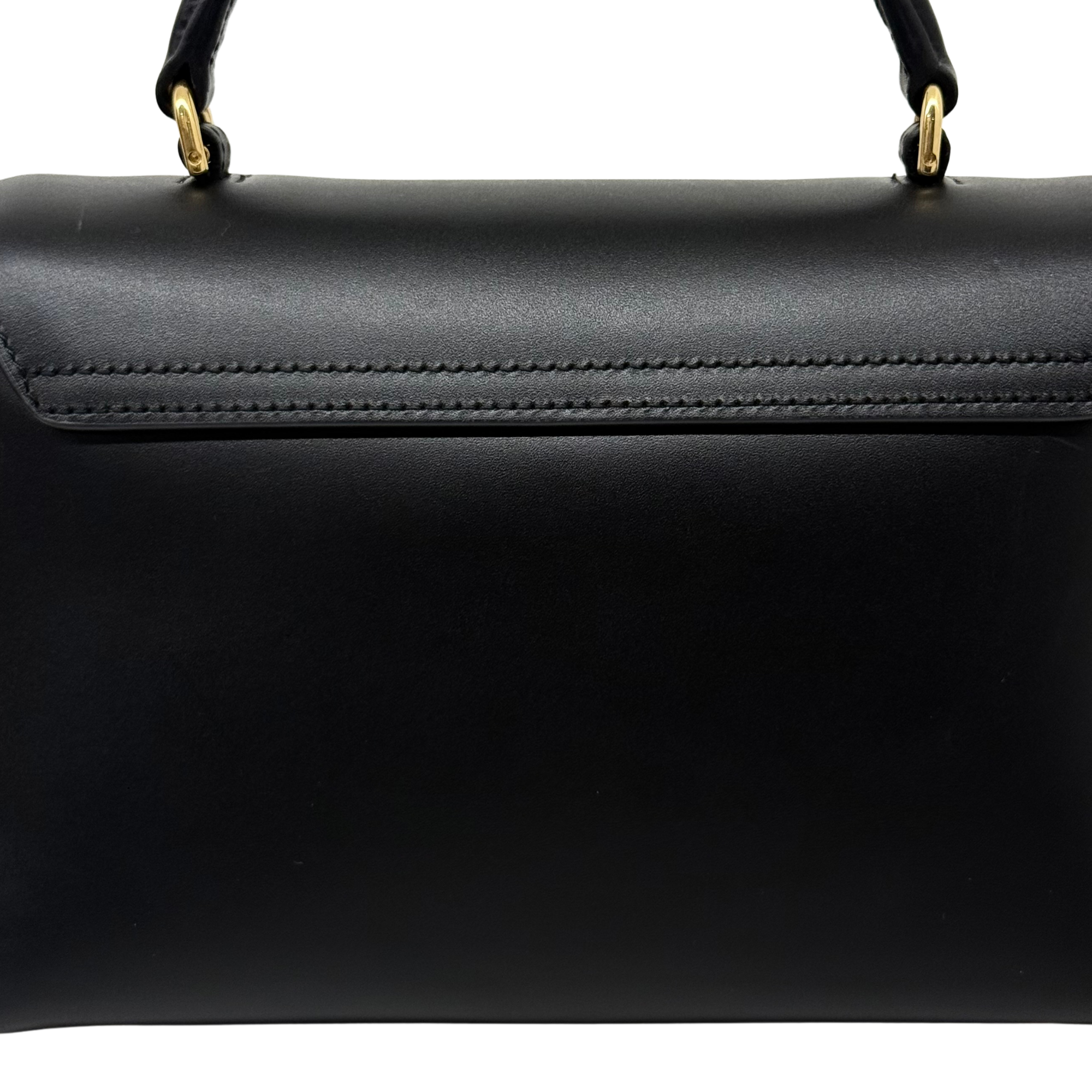 Black leather bag with top stitched edge and gold-tone handle rings