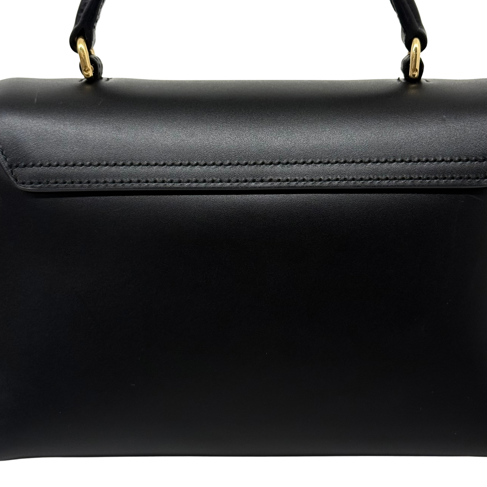 Black leather bag with top stitched edge and gold-tone handle rings