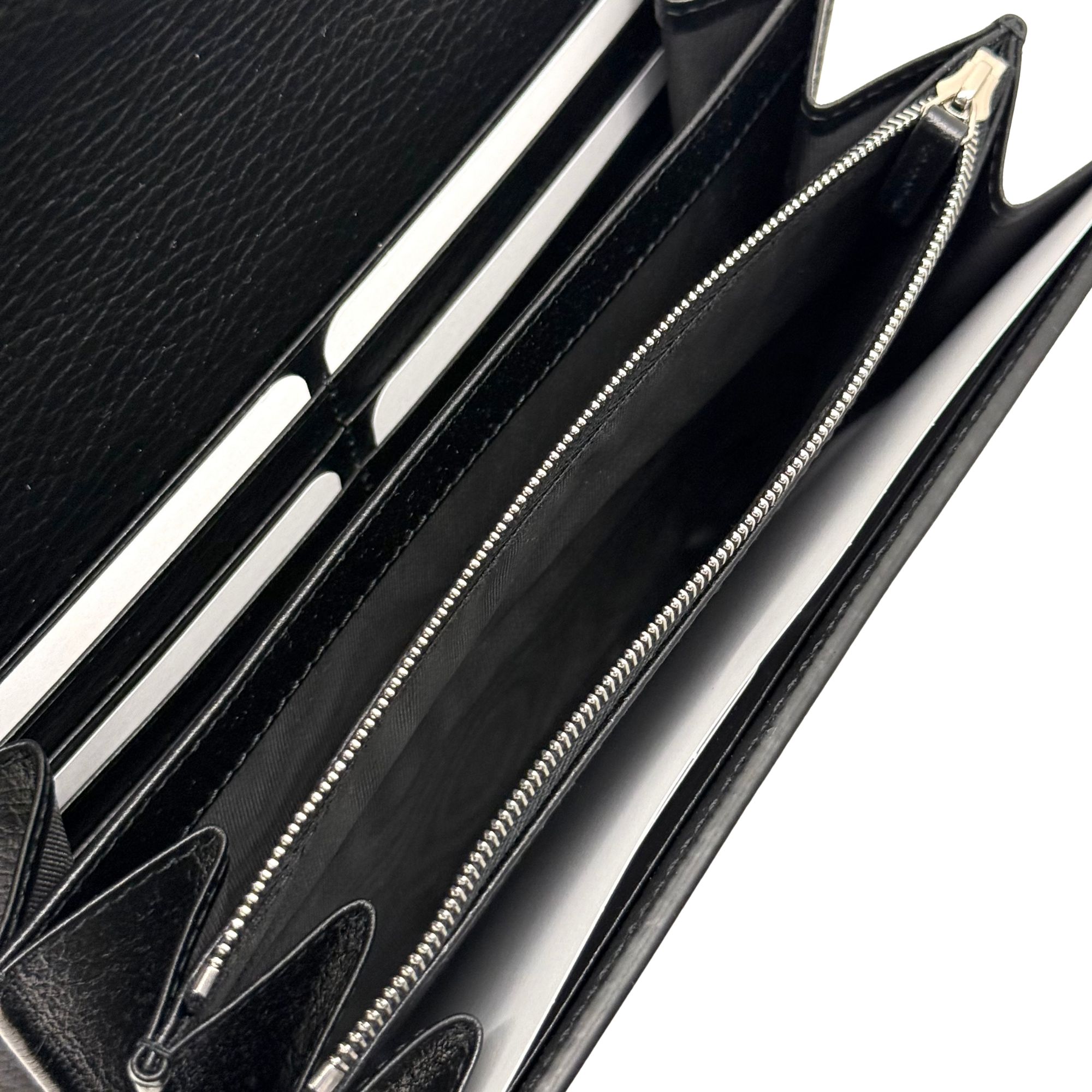 Gucci black leather clutch interior view with dual zipper compartments