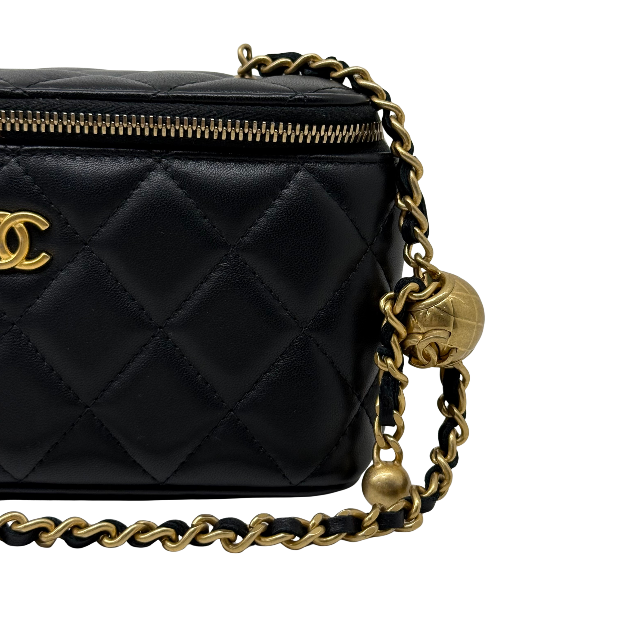 Black quilted leather crossbody with gold chain, side knot detail, and zip edge
