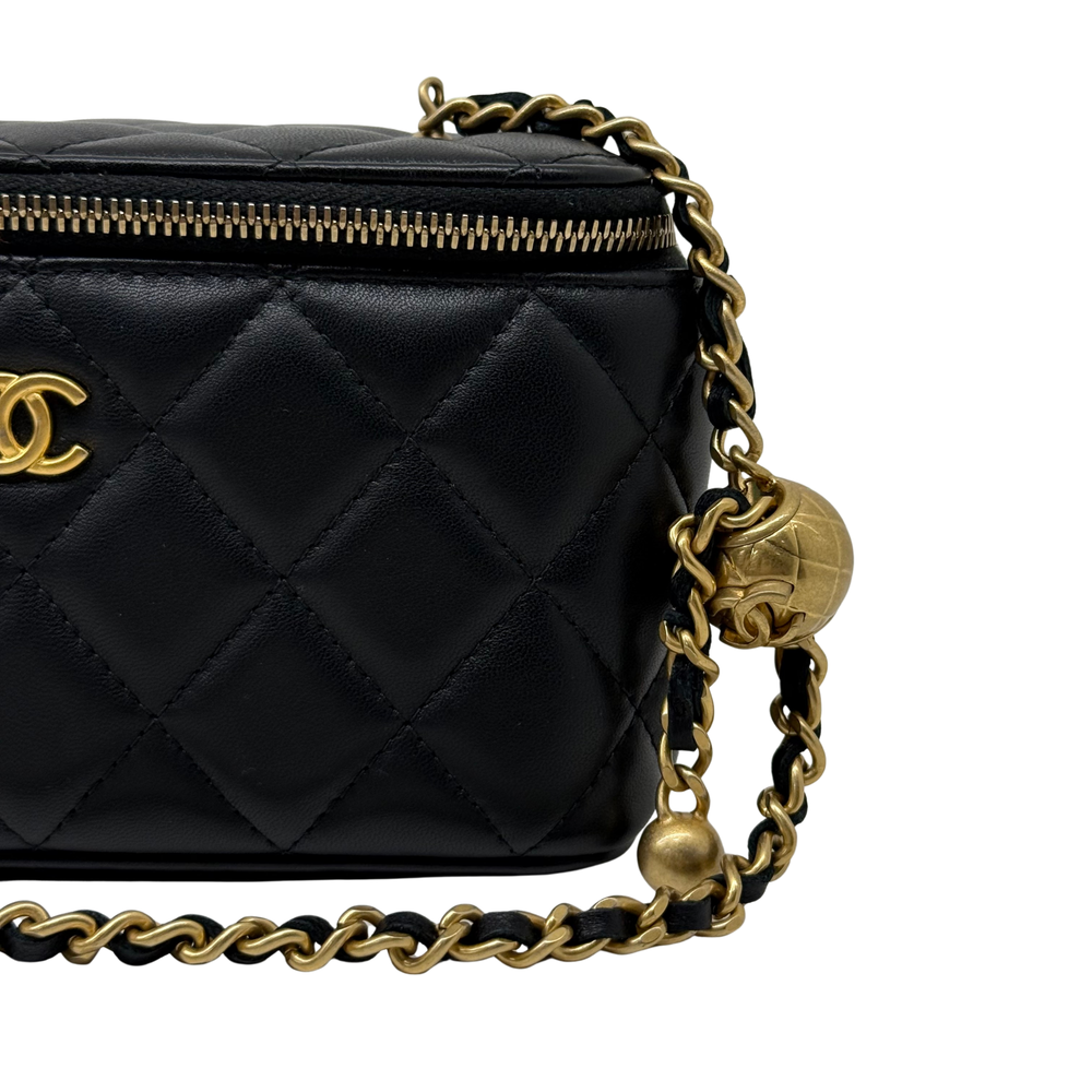 Black quilted leather crossbody with gold chain, side knot detail, and zip edge
