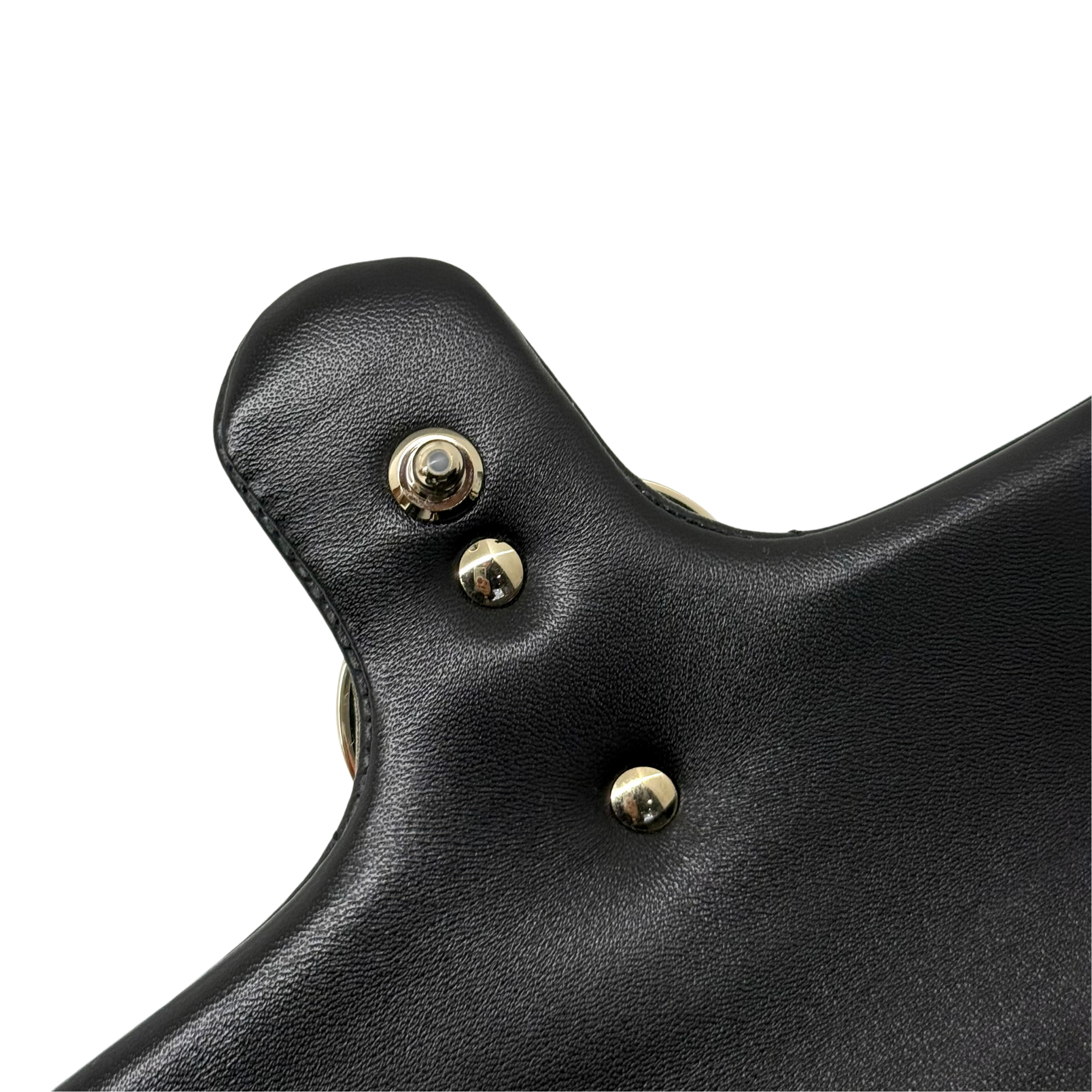 Gucci shoulder bag close-up of black leather flap with round gold snaps