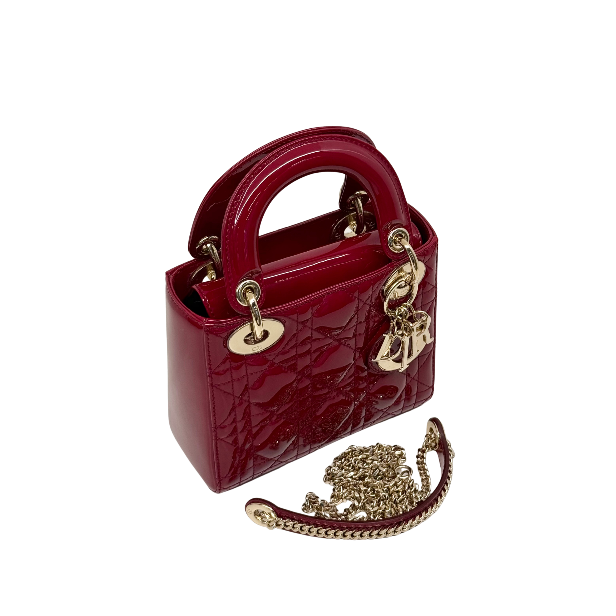 Red patent leather mini handbag with gold chain strap and quilted front design
