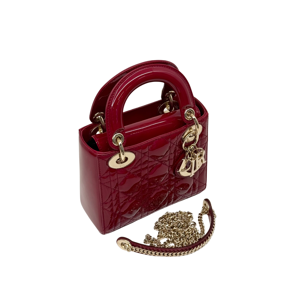 Red patent leather mini handbag with gold chain strap and quilted front design