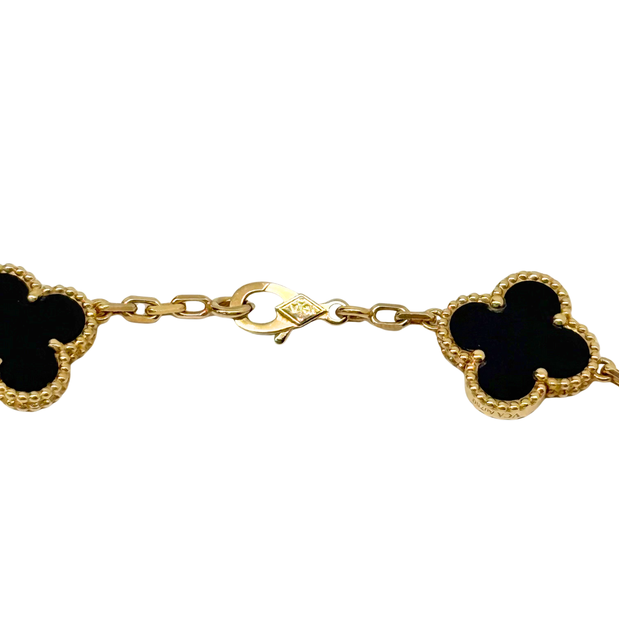 Van Cleef necklace close-up of gold-tone clasp chain with black clover charms