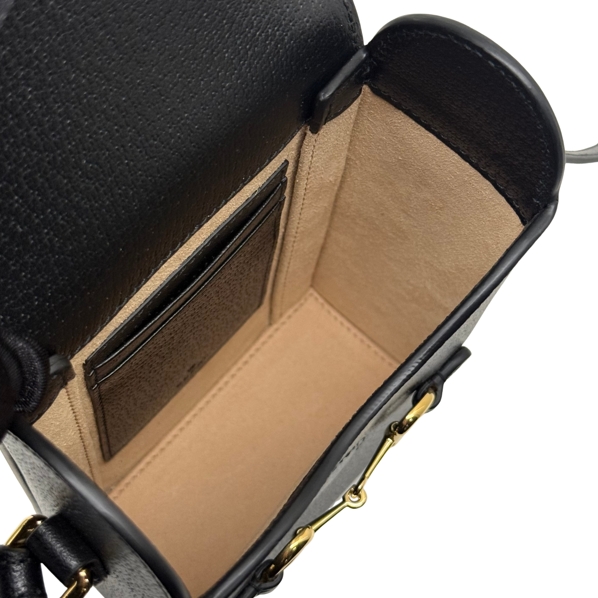 Gucci black leather mini crossbody bag, interior lining visible and top opening