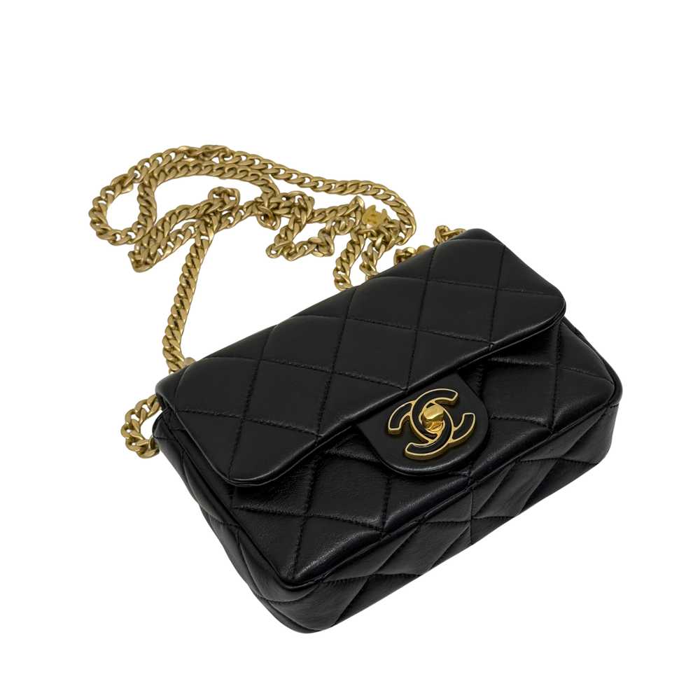Black quilted mini shoulder bag with gold-tone chain strap and logo clasp