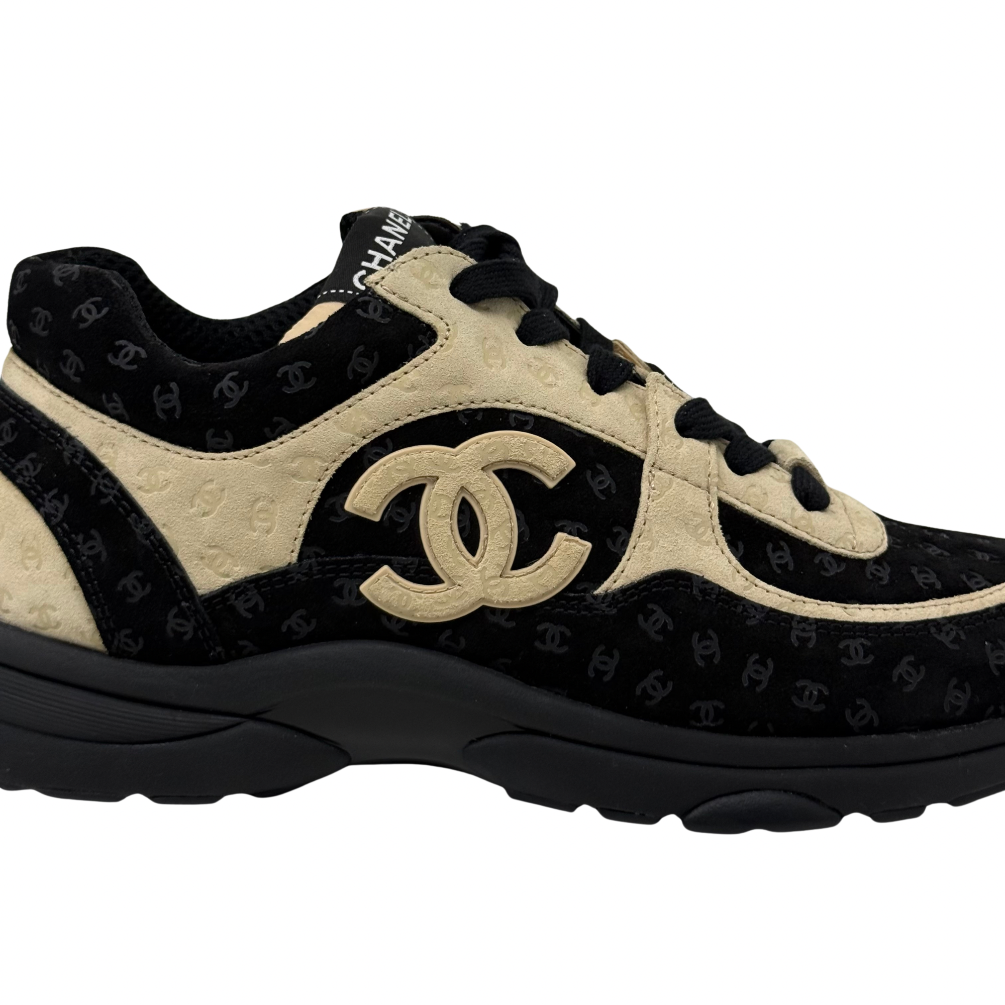 Black and beige Chanel sneakers side view with large interlocking CC logo