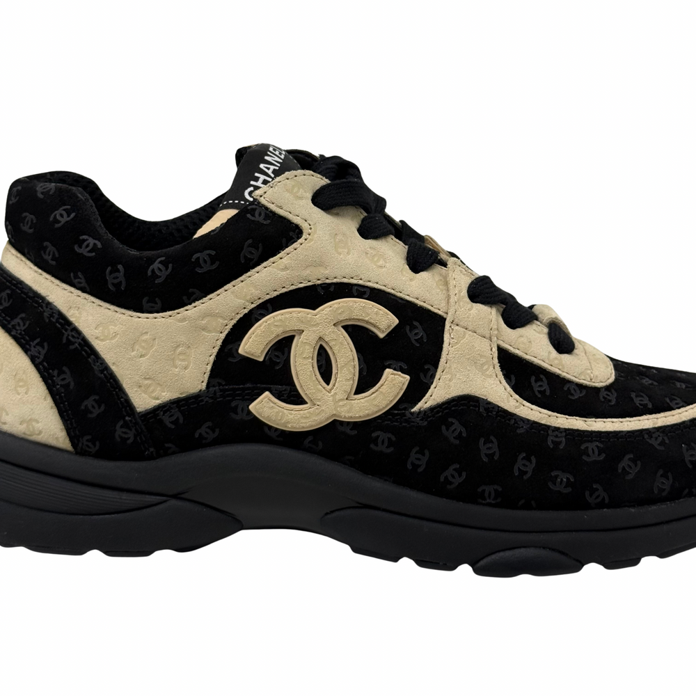 Black and beige Chanel sneakers side view with large interlocking CC logo