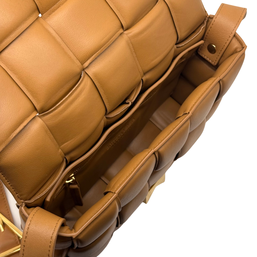 Tan leather crossbody bag interior view with zipper pocket and strap hardware