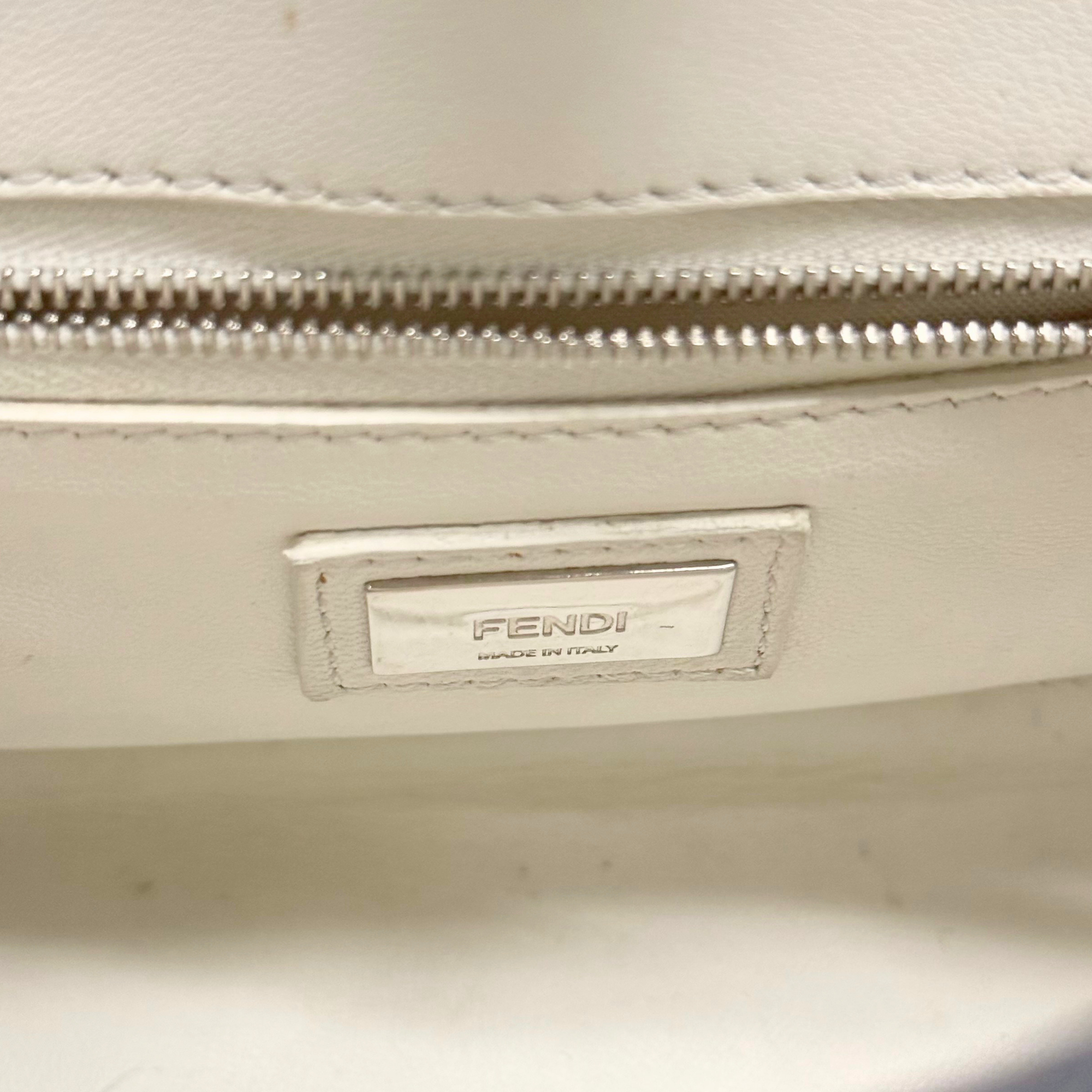 FENDI logo tag on light lining inside handbag with zipper