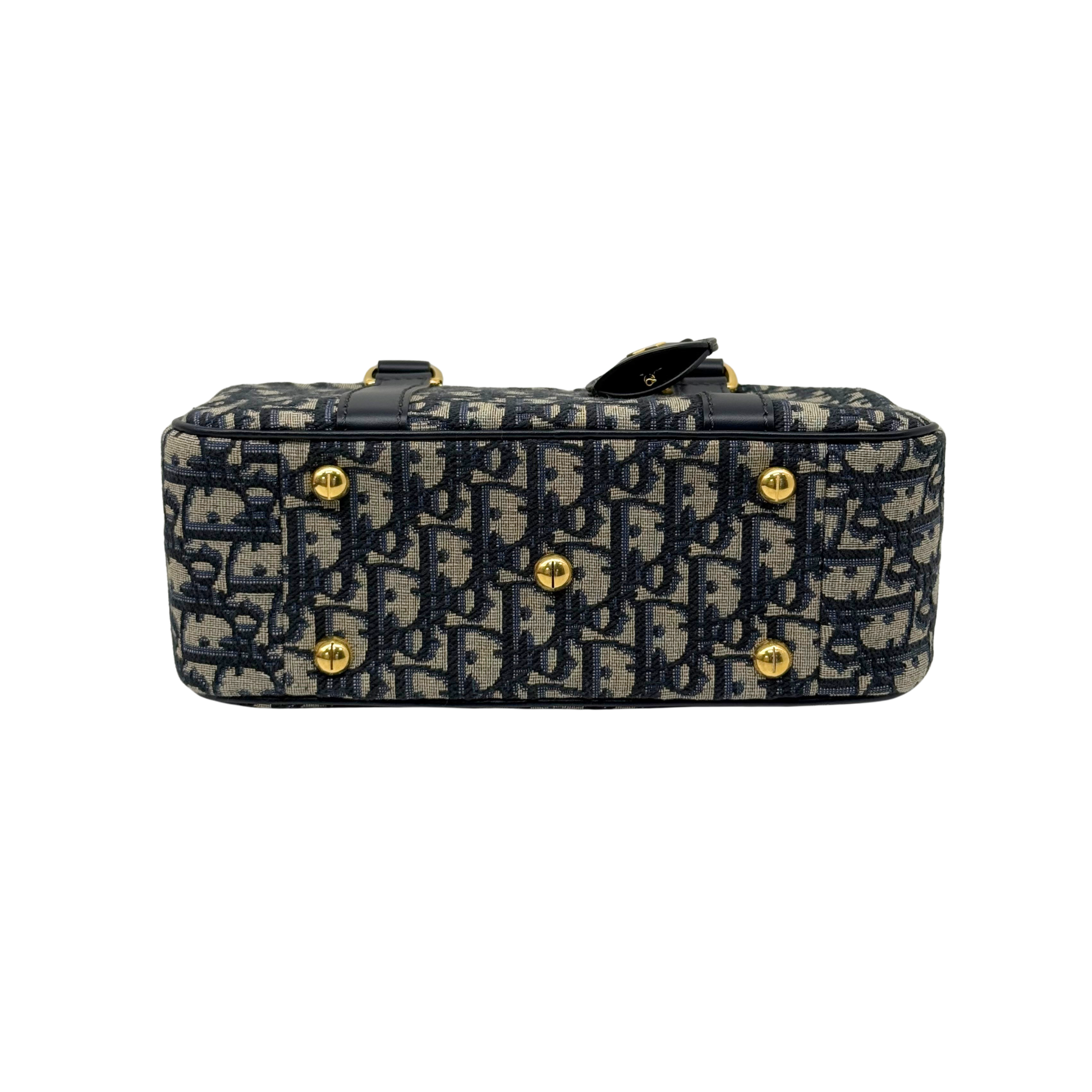 Navy and cream monogram mini handbag top view with gold-tone studs and closure