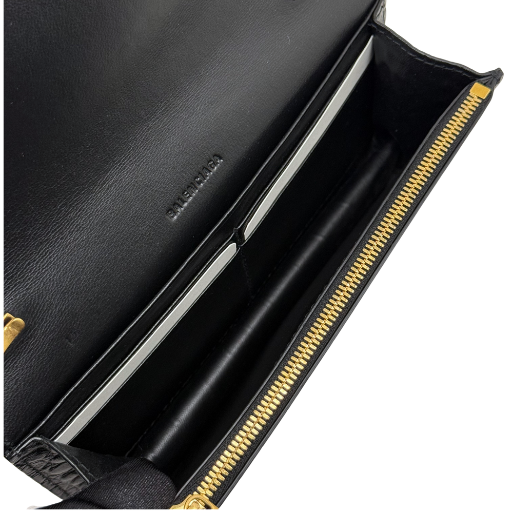 Black leather interior with zip opening and gold-tone zipper on shoulder bag.