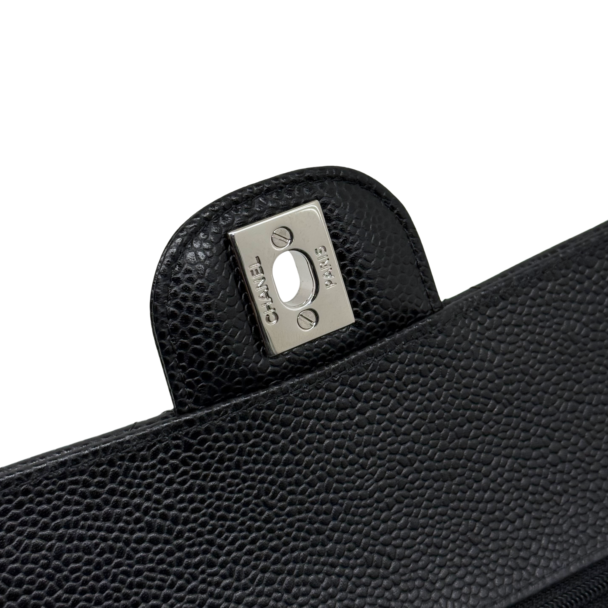 Black leather bag flap with silver-tone stud hardware and pebble texture