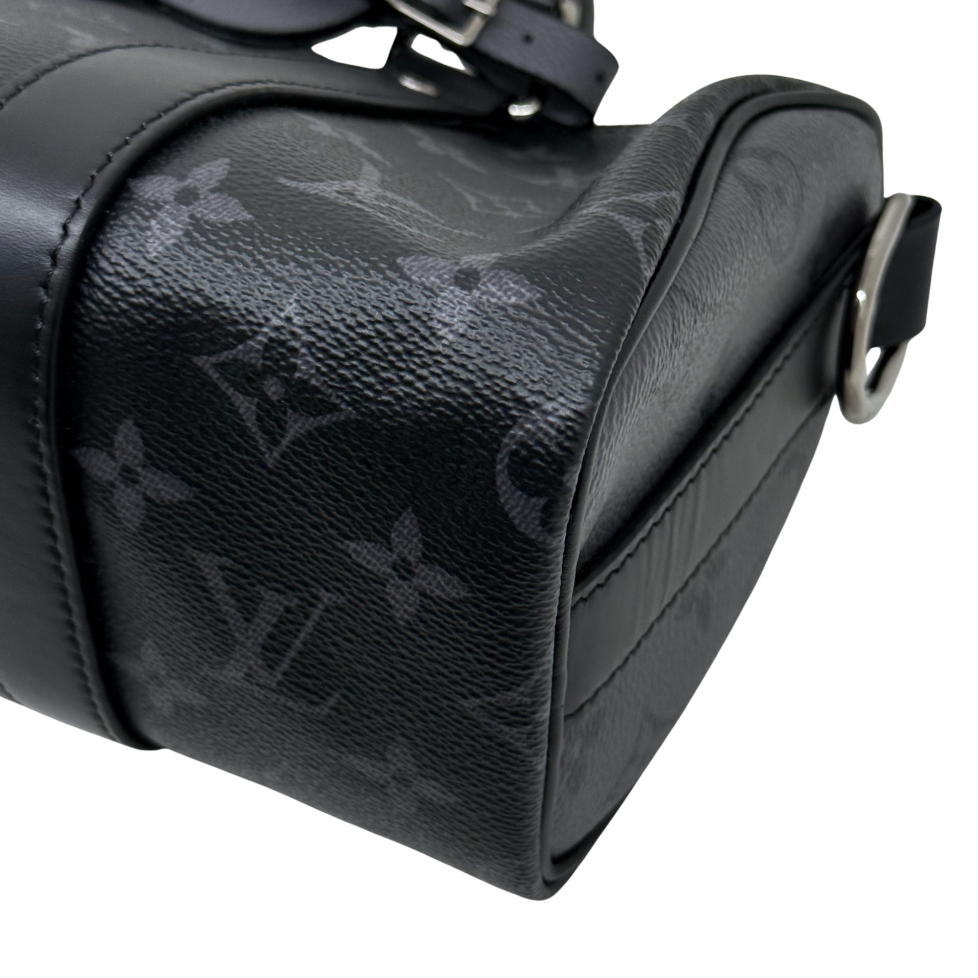 Black monogram handbag side with leather piping and top carry handle
