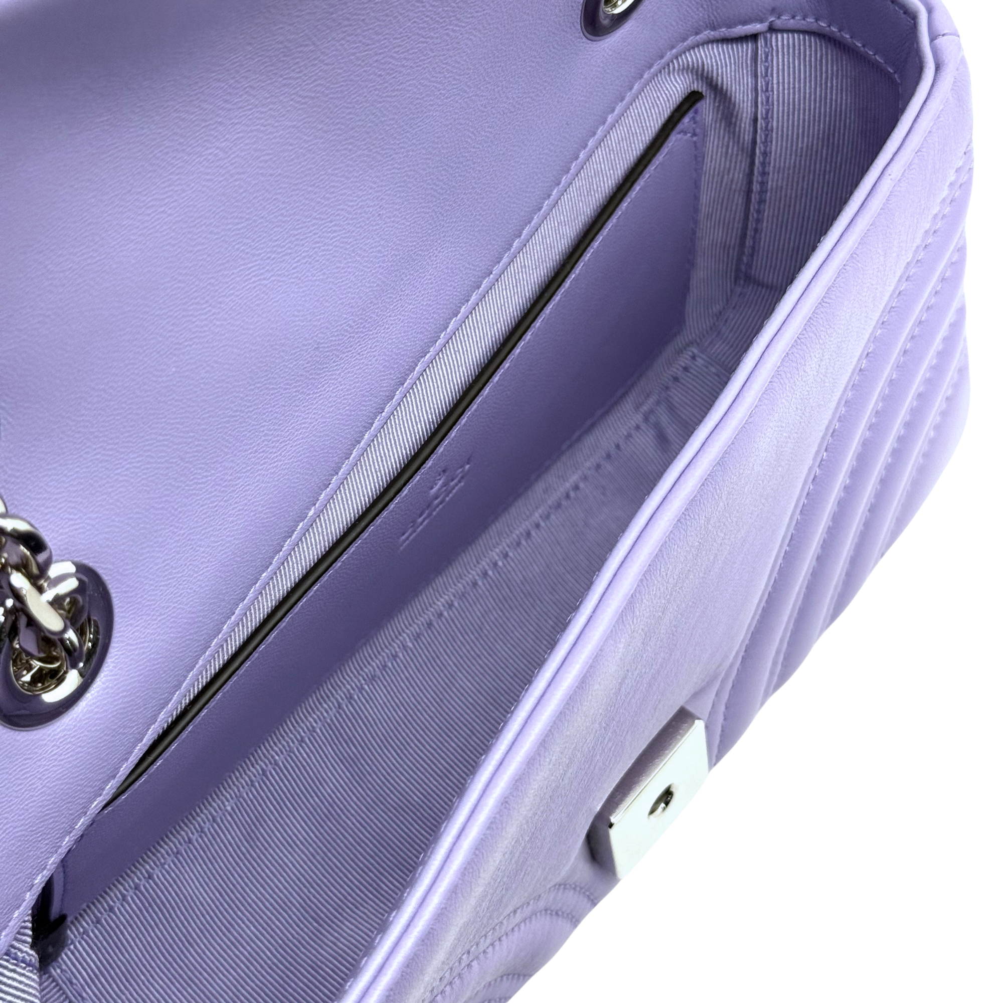 Lavender quilted mini bag detail with zipper-like trim and textured side panel