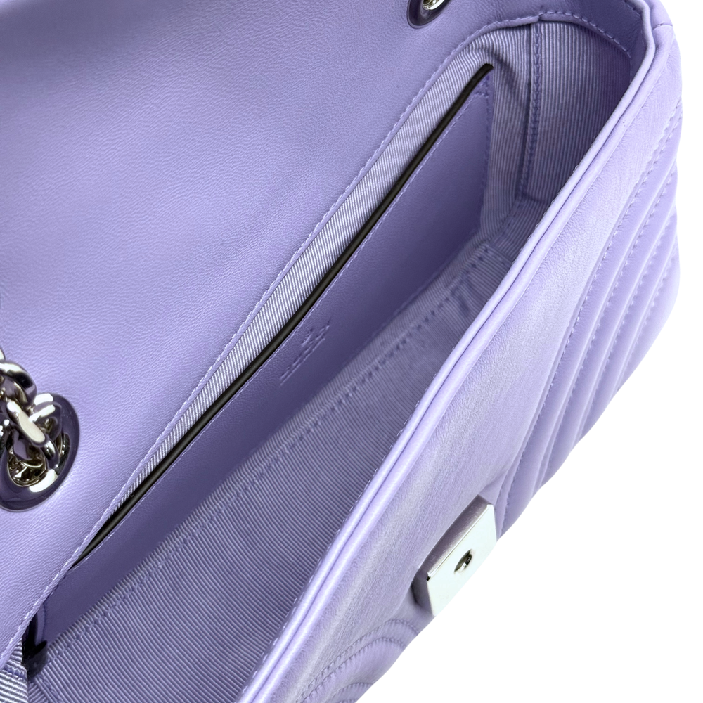 Lavender quilted mini bag detail with zipper-like trim and textured side panel