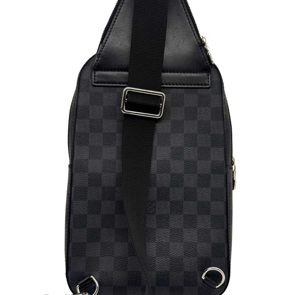 Dark checkered crossbody bag with front strap, metal rings, and top edge stitching