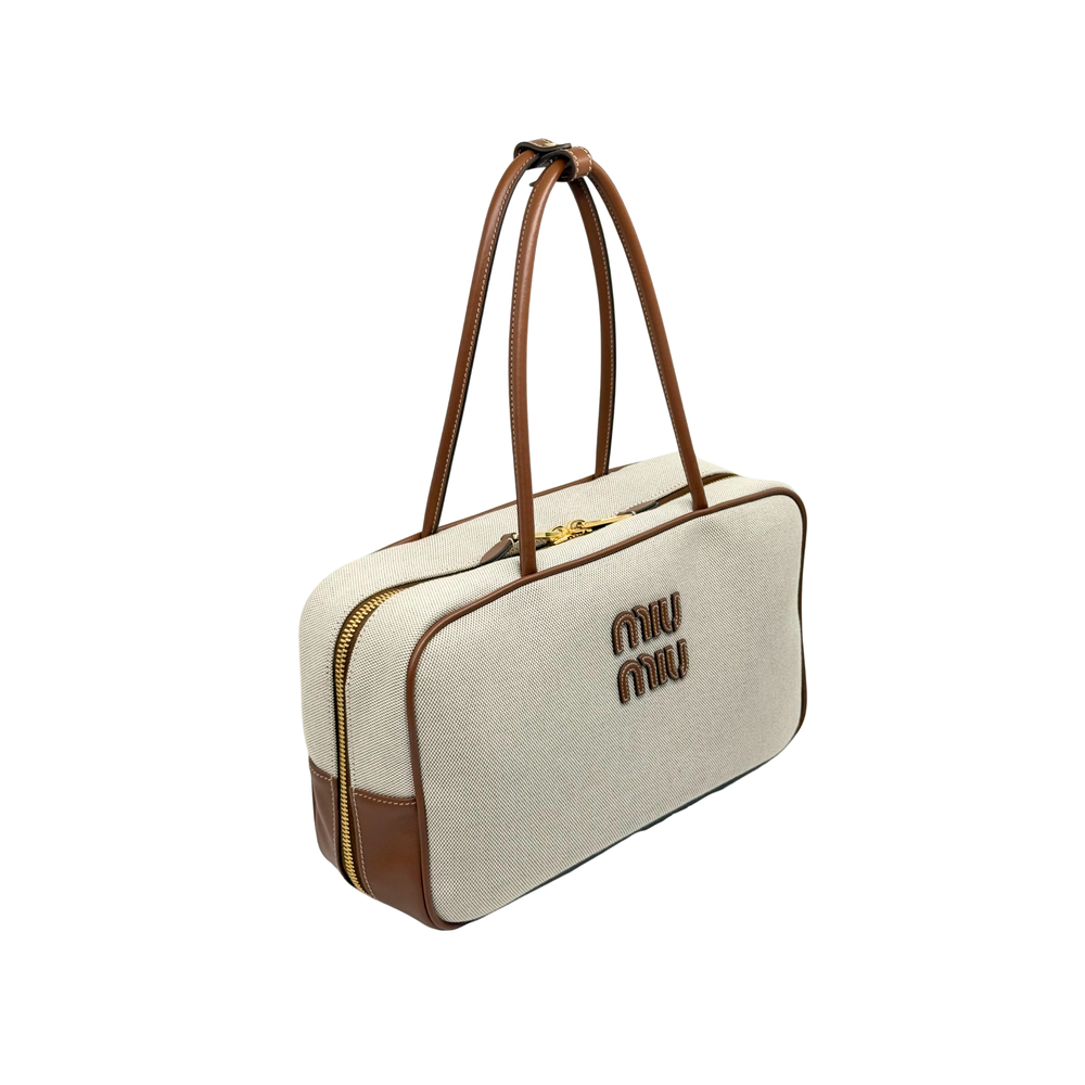 Miu Miu canvas duffel bag with top handles, side zipper and gold trim