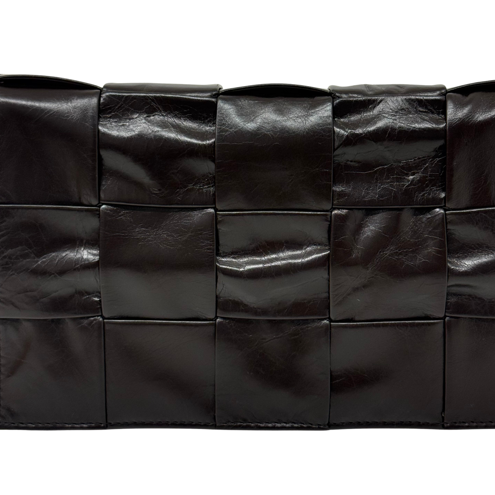 Black quilted leather bag with square panel stitching and textured finish
