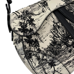Black-and-white saddle bag front panel with palm tree toile print and black leather strap