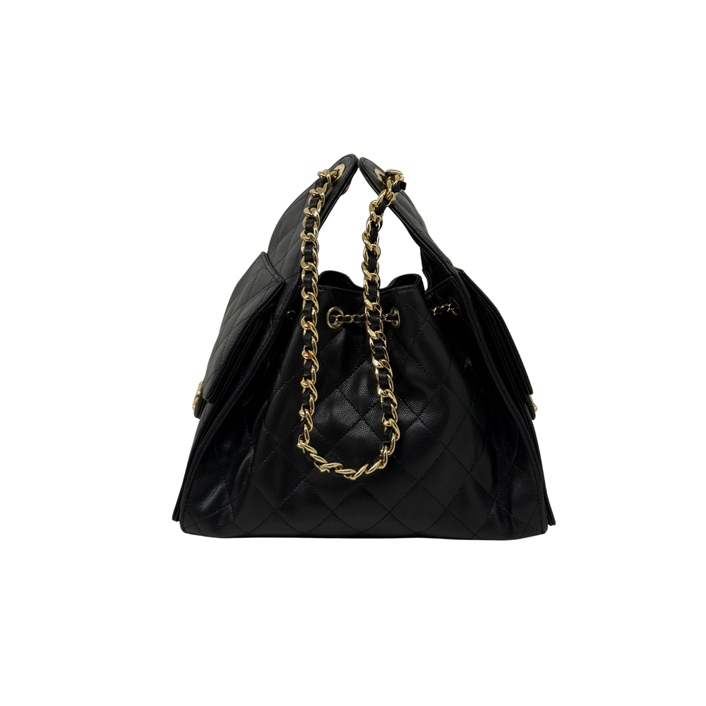 Black quilted satchel handbag with gold chain handles and dangling charm