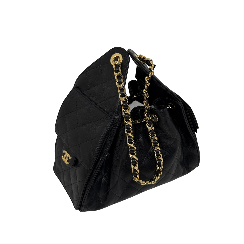 Black quilted handbag with gold CC logo plaque, top handles, and chain strap