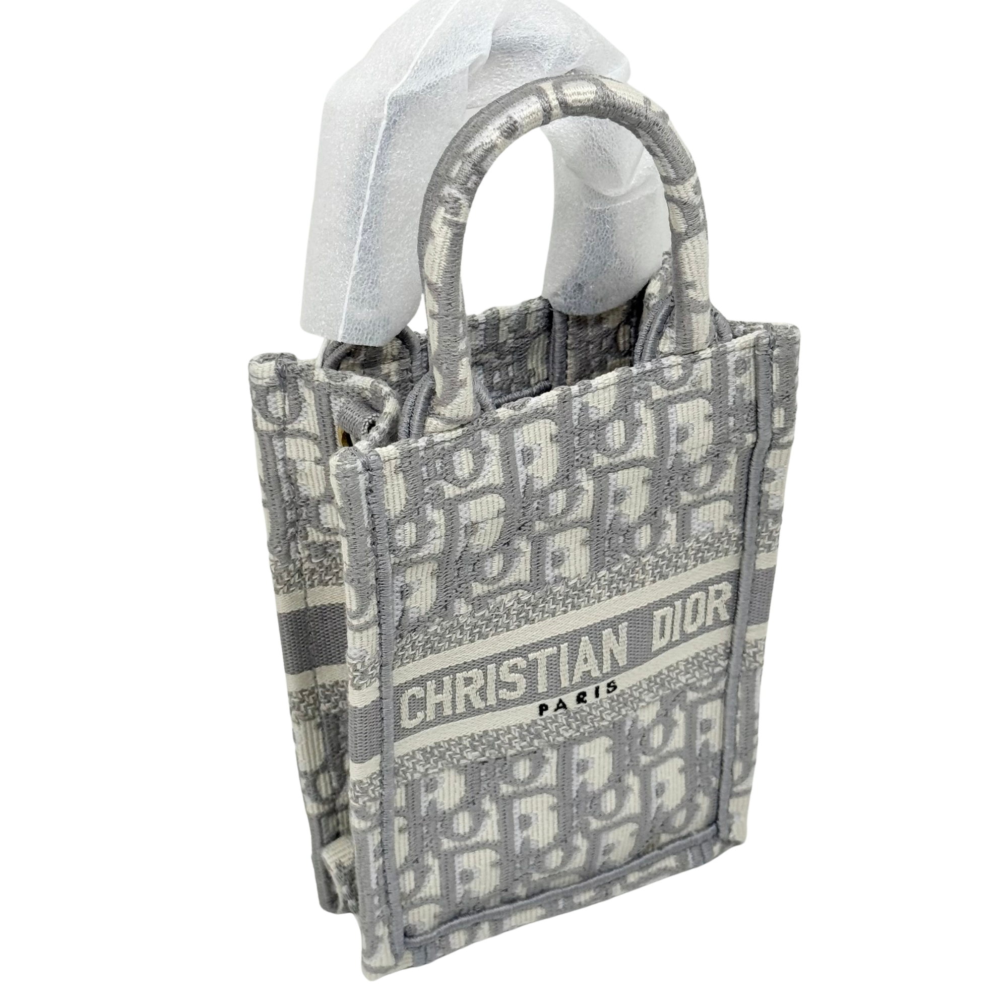 Dior mini tote with top handles, allover monogram print and "CHRISTIAN DIOR PARIS"