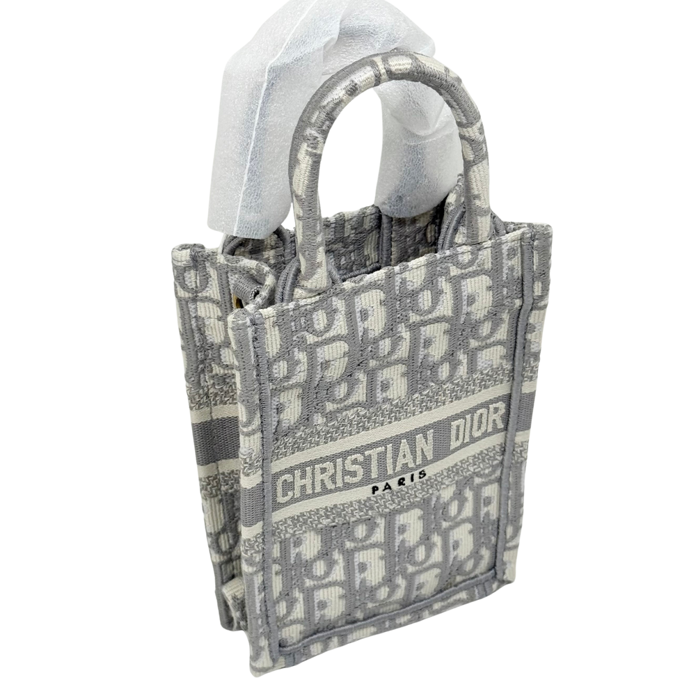 Dior mini tote with top handles, allover monogram print and "CHRISTIAN DIOR PARIS"