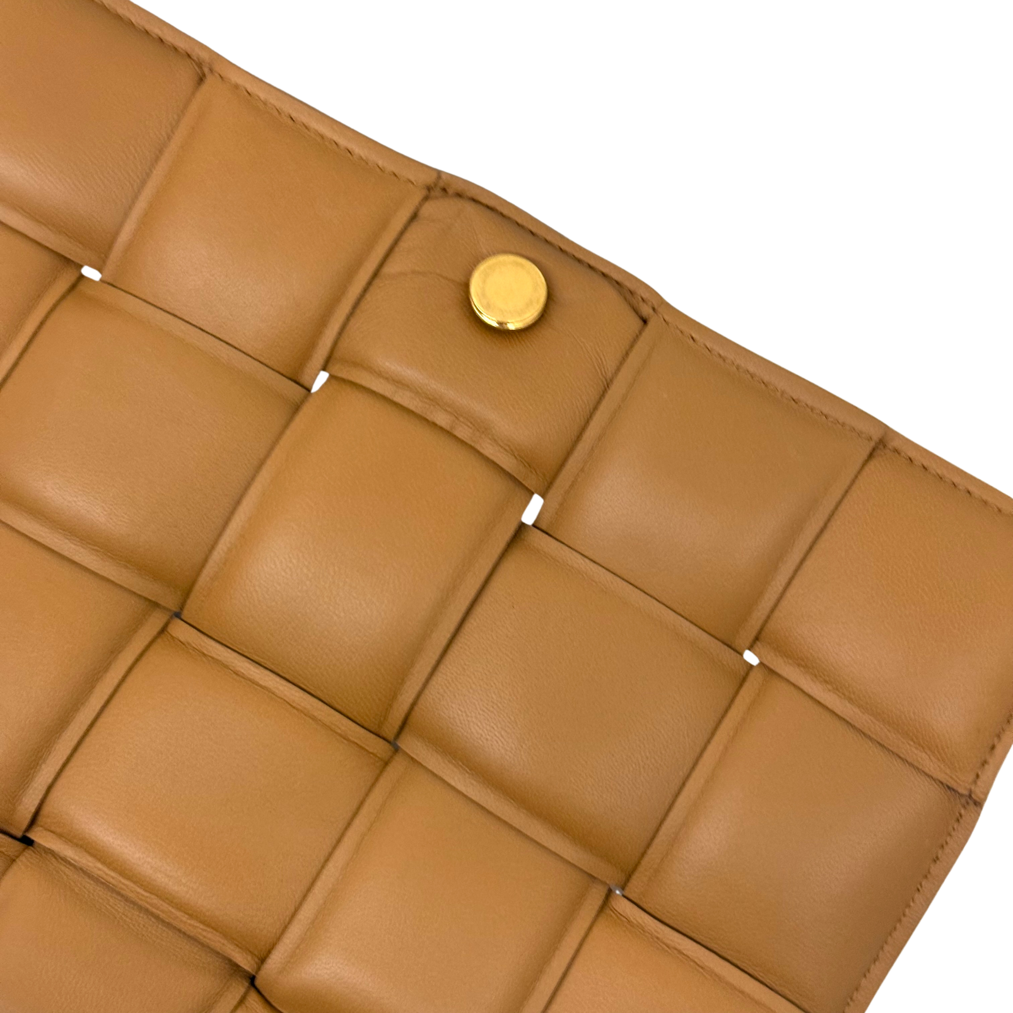 Tan leather bag interior panel lining with gold snap button