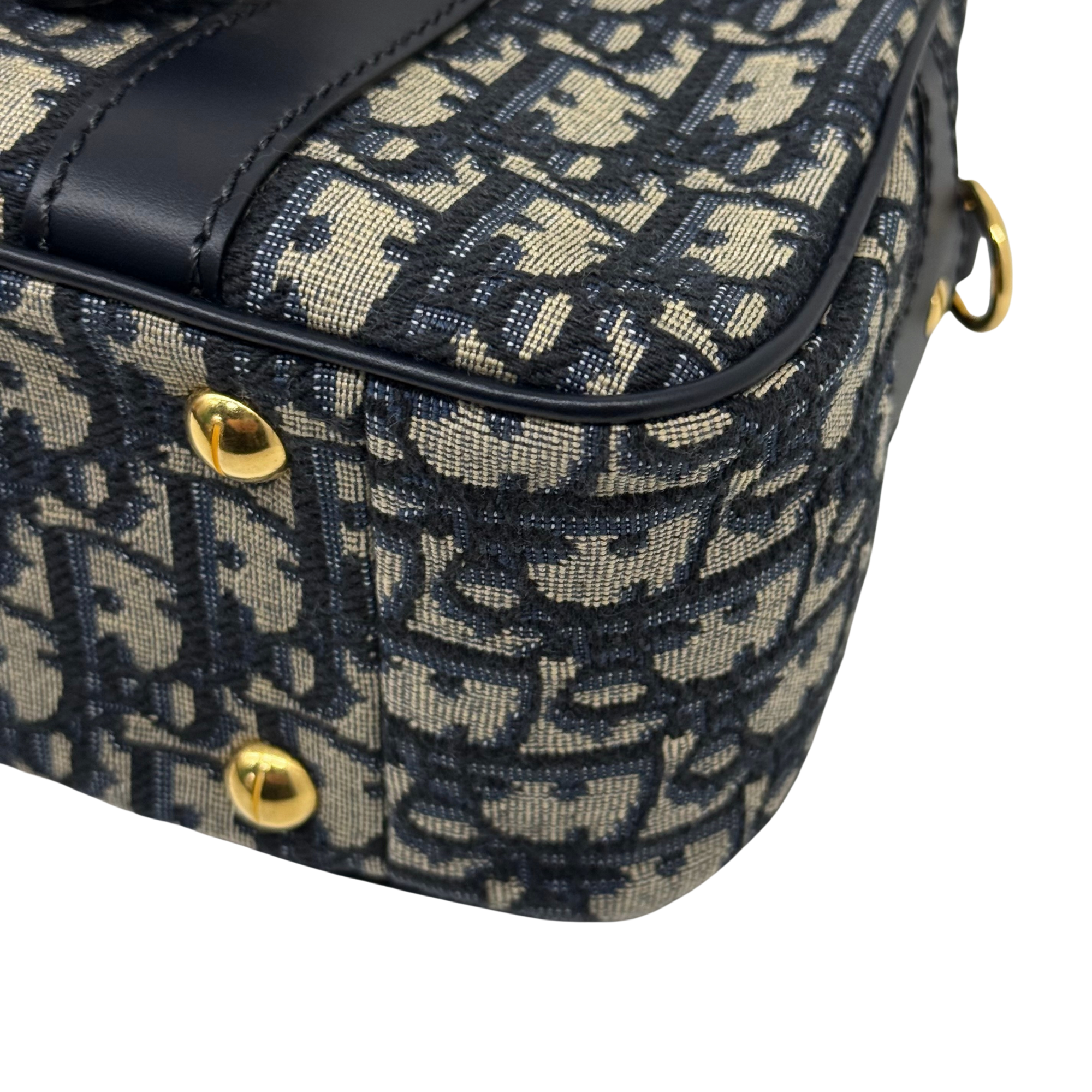 Navy and cream monogram handbag corner with black trim and gold-tone snap hardware