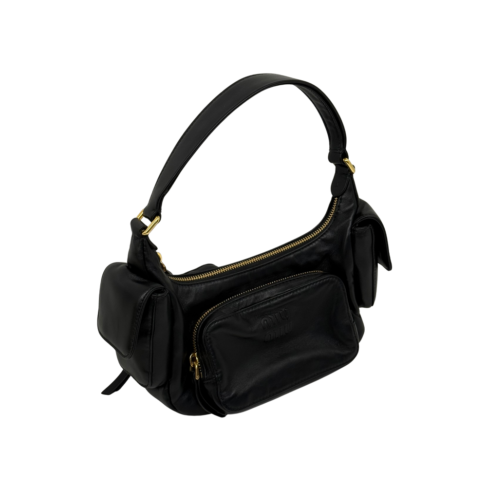 Black leather shoulder bag with gold zipper top, bow-like side ties, and carry handles