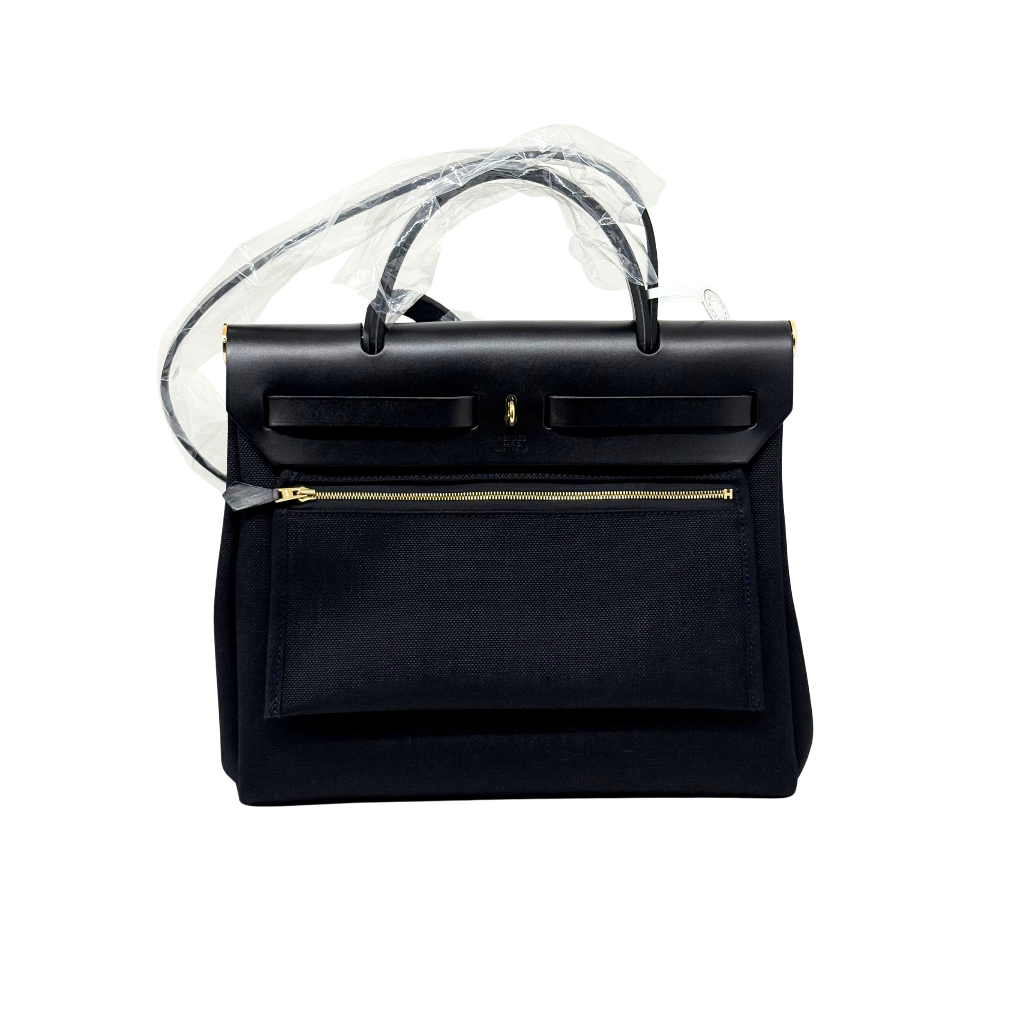 Hermes black leather handbag with top handles, front flap, and gold zipper